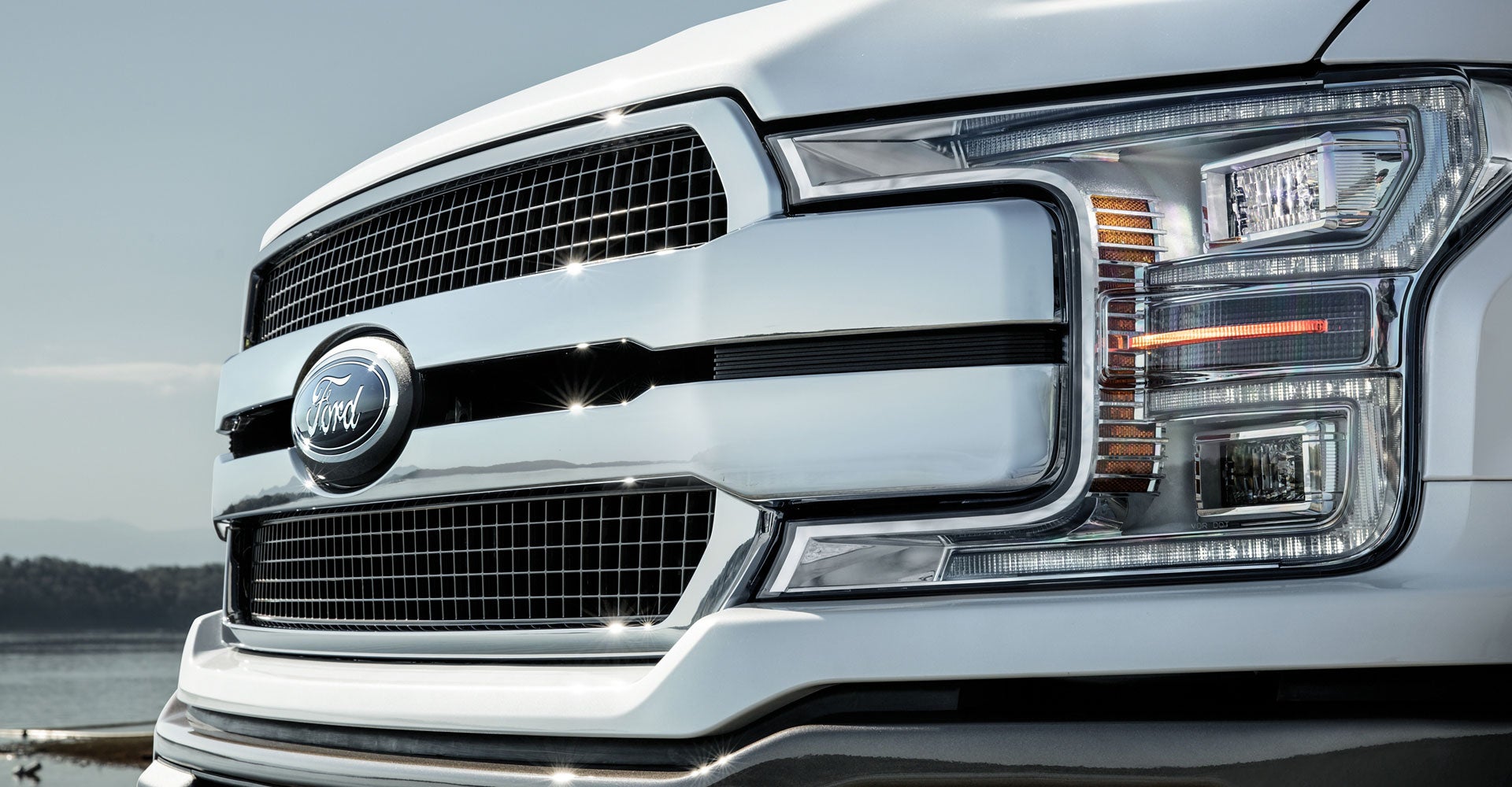 Close-up of Ford truck front grille and headlight