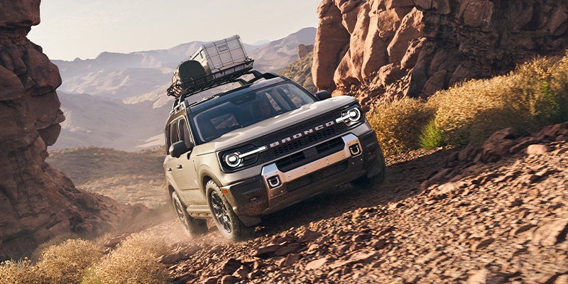 A 2025 Ford Bronco Badlands® tackling off roading with a full roof rack in Benton, AR 