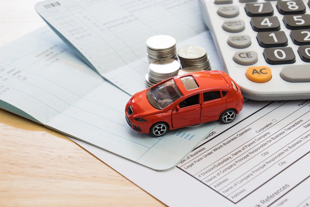 car on financial documents with calculator