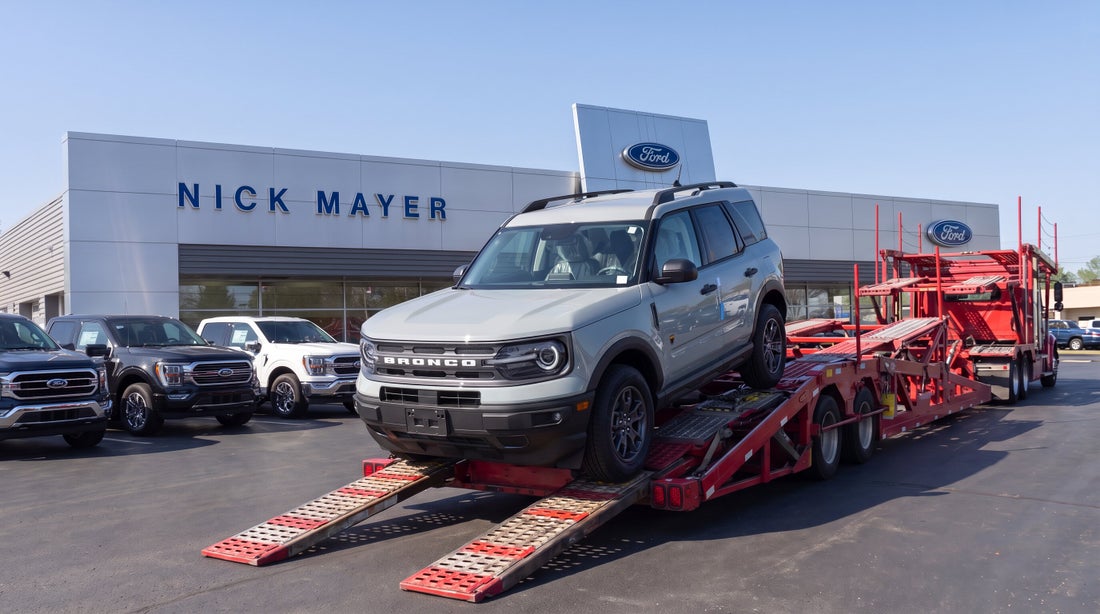 A new Ford Bronco Sport being unloaded from a car carrier outside Nick Mayer Ford