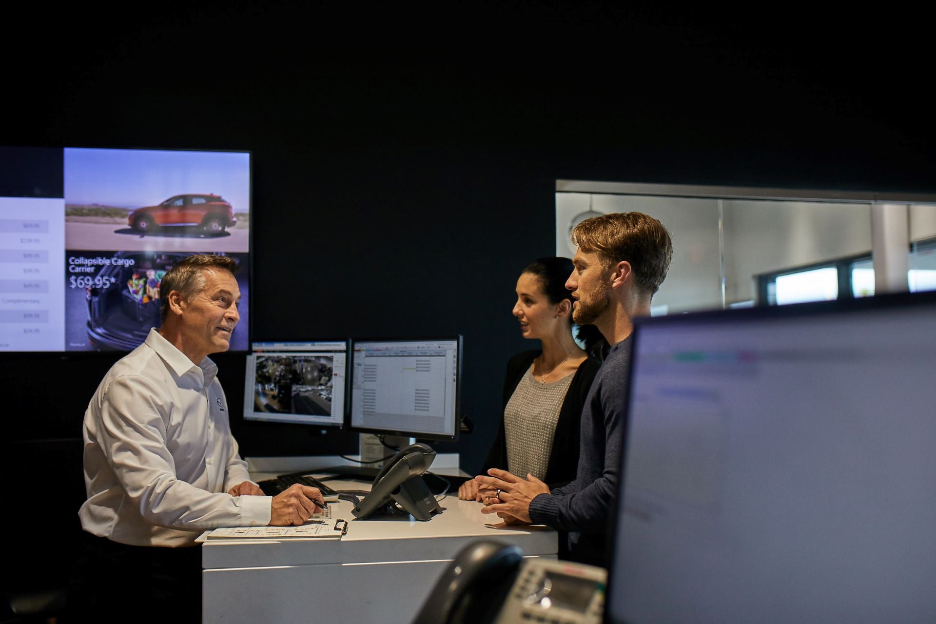 Mazda dealer speaking to clients