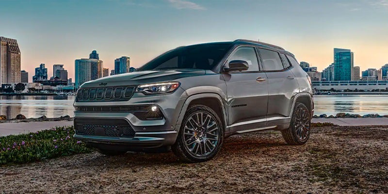 2023 Jeep Compass on a shore with water and a city behind it near Lancaster, OH