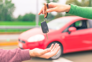 Person Handing Keys Over When Selling a Car