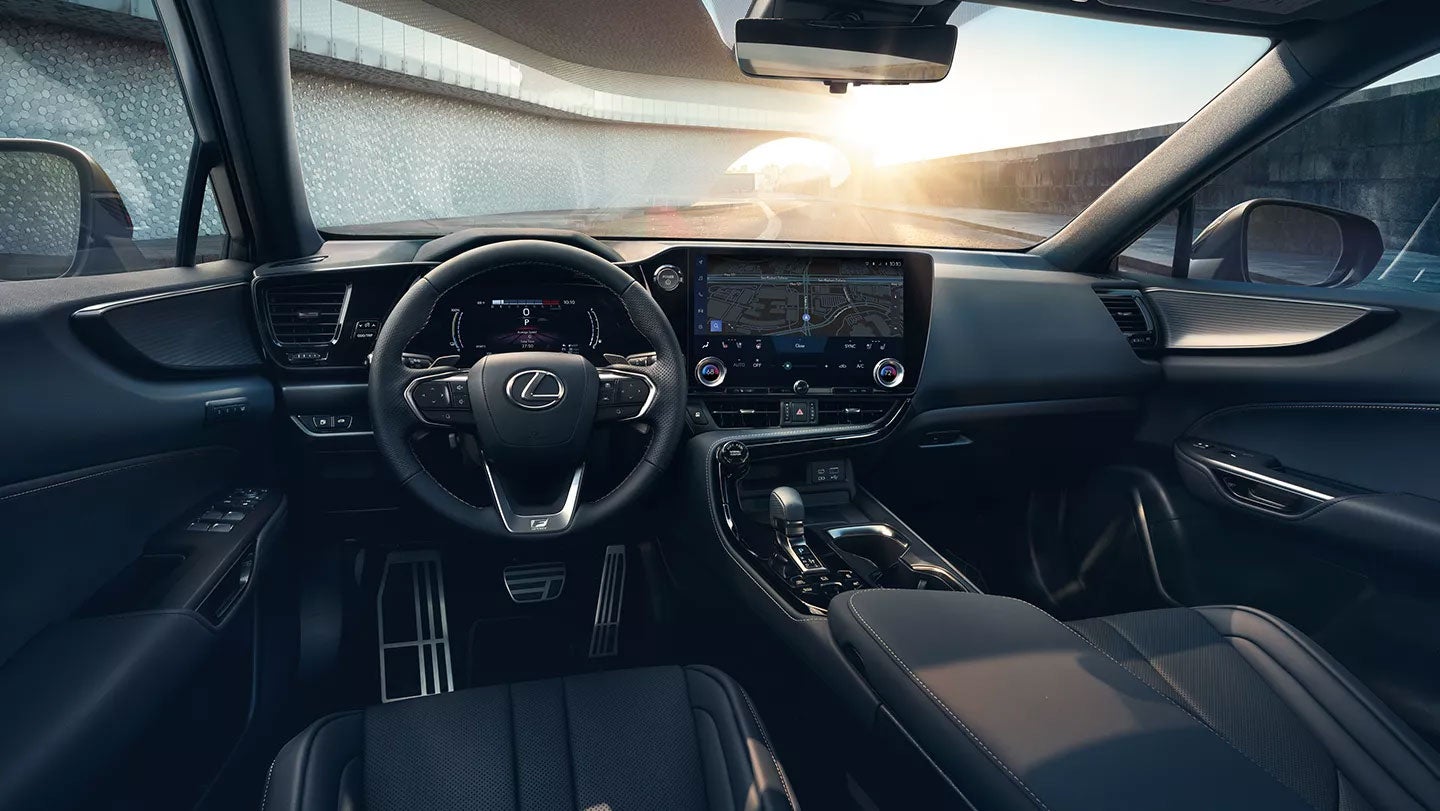 A Lexus car interior showcasing a modern dashboard with a touchscreen, leather seats, and ambient lighting.