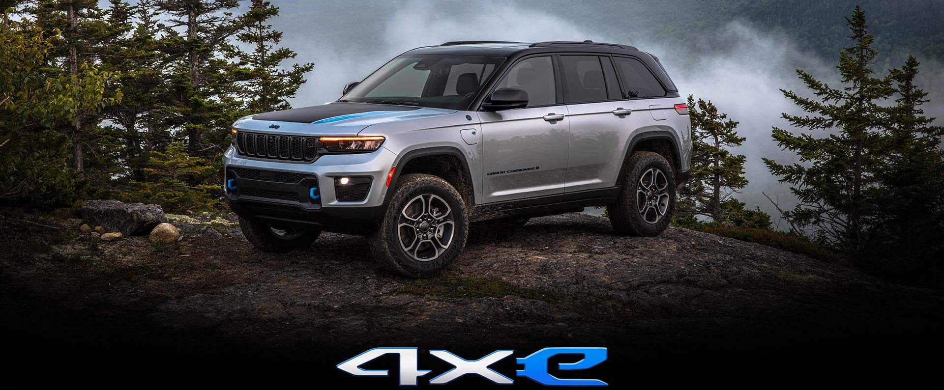 Jeep Grande Cherokee 4XE The 2023 Jeep Grand Cherokee 4xe parked atop a boulder.