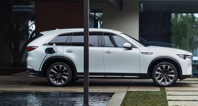 A parked 2026 Mazda CX-90 PHEV charging