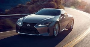 A silver 2020 Lexus 500 Hybrid gliding down the road.