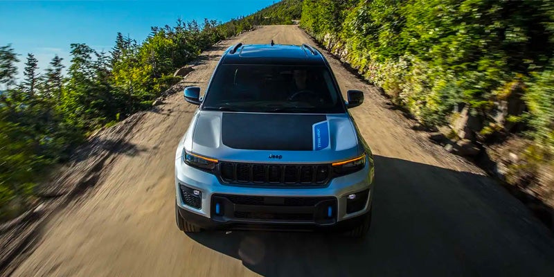 A 2025 Jeep Grand Cherokee driving down the road with its various trim options in Starke, FL 