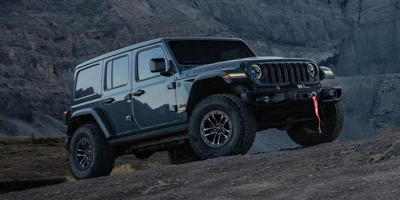 2026 Black Jeep Wrangler climbing rocks