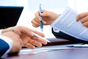 People signing paperwork | Greenwich, CT