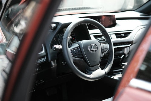 The driver side door to a Lexus UX opening and showing the driver side interior