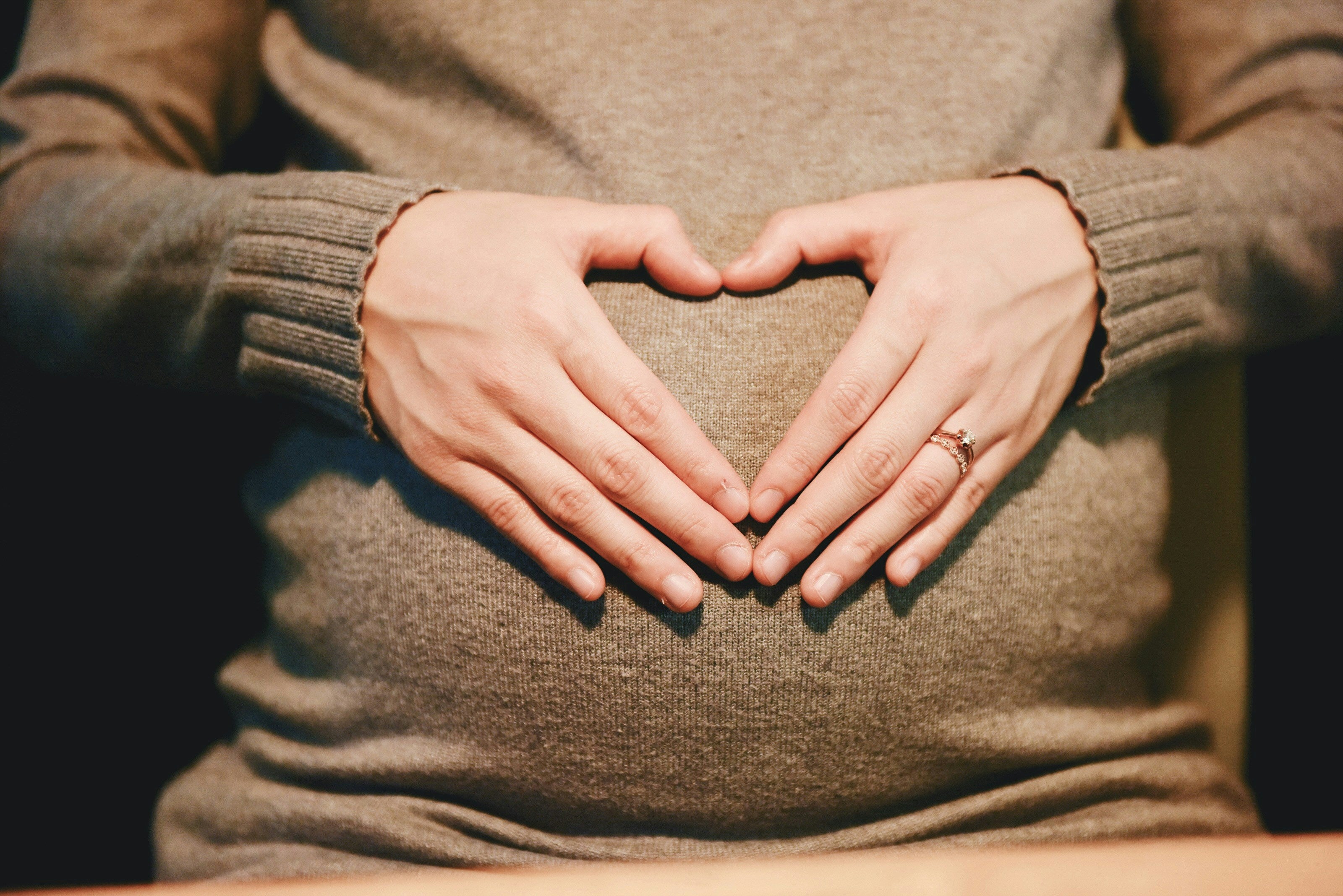 Pregnant woman with her hands on her belly