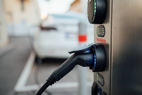 Public charging station with an EV cable plugged in