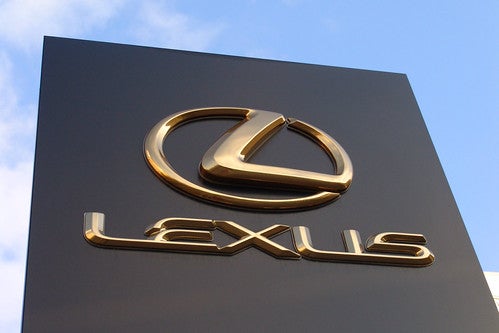 A Lexus dealership storefront Lexus sign