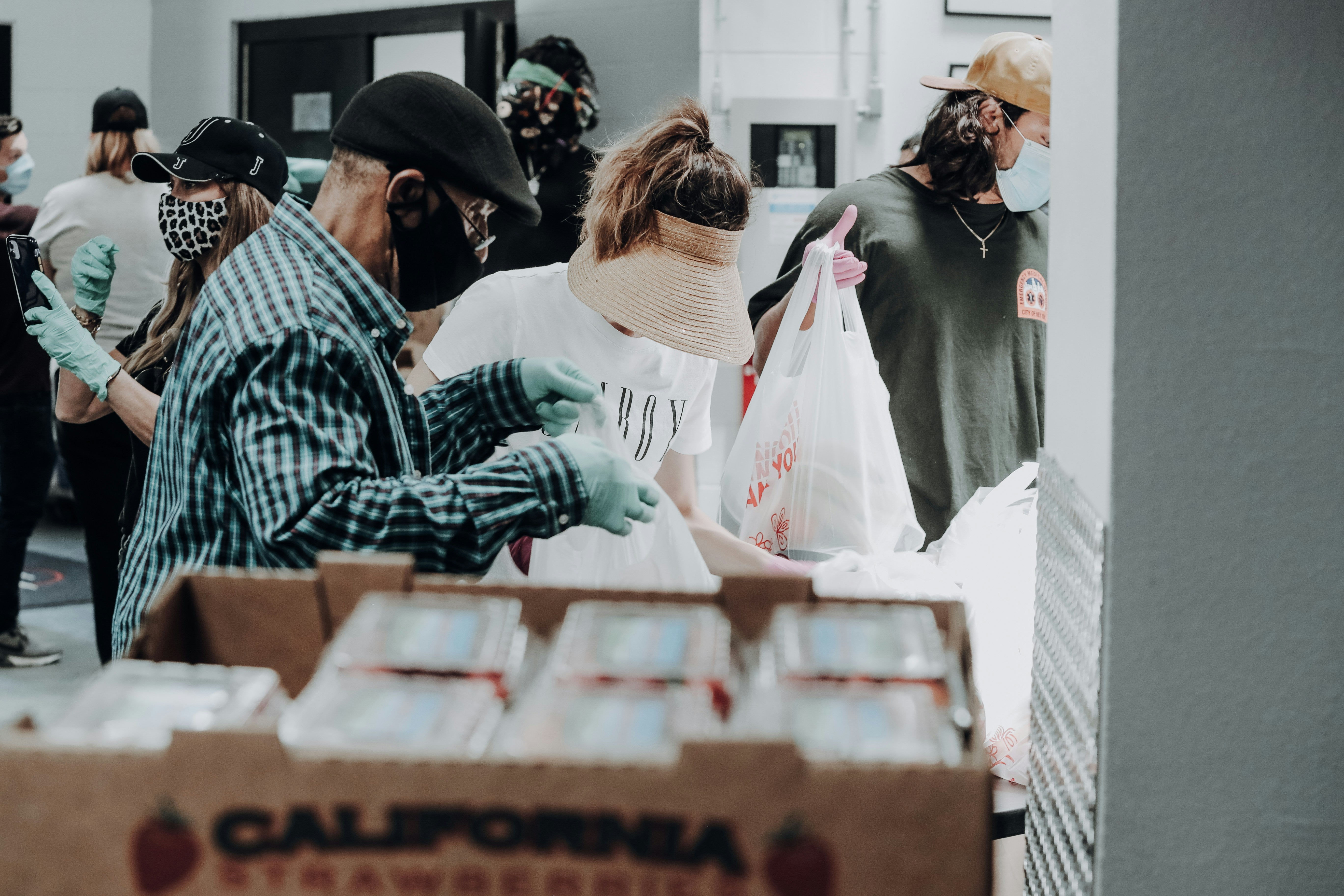 Volunteers filling bags with food
