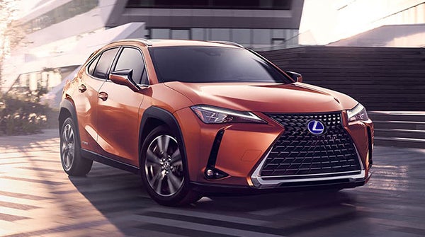 orange Lexus ux-250h parked outside on the street