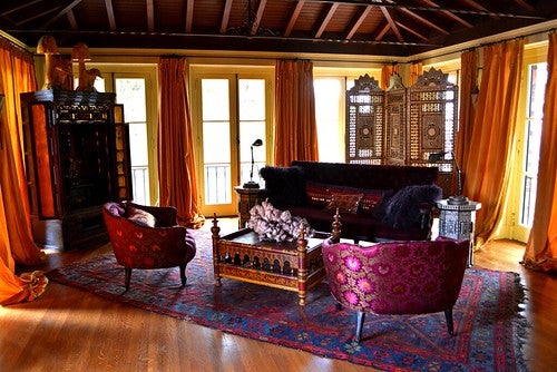 A bed and breakfast room bedecked in woodsy earth tones and subtle neutrals