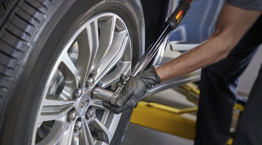 Tire being serviced on a Cadillac