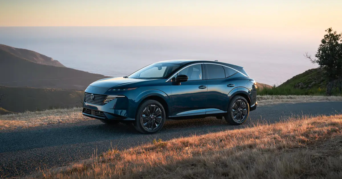 2026 Nissan Murano driving on a windy road with an ocean backdrop