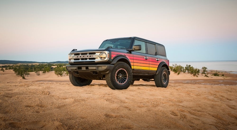 A grey 2025 Ford Bronco Free Wheeling Edition is shown from the side after leaving a Ford dealer.