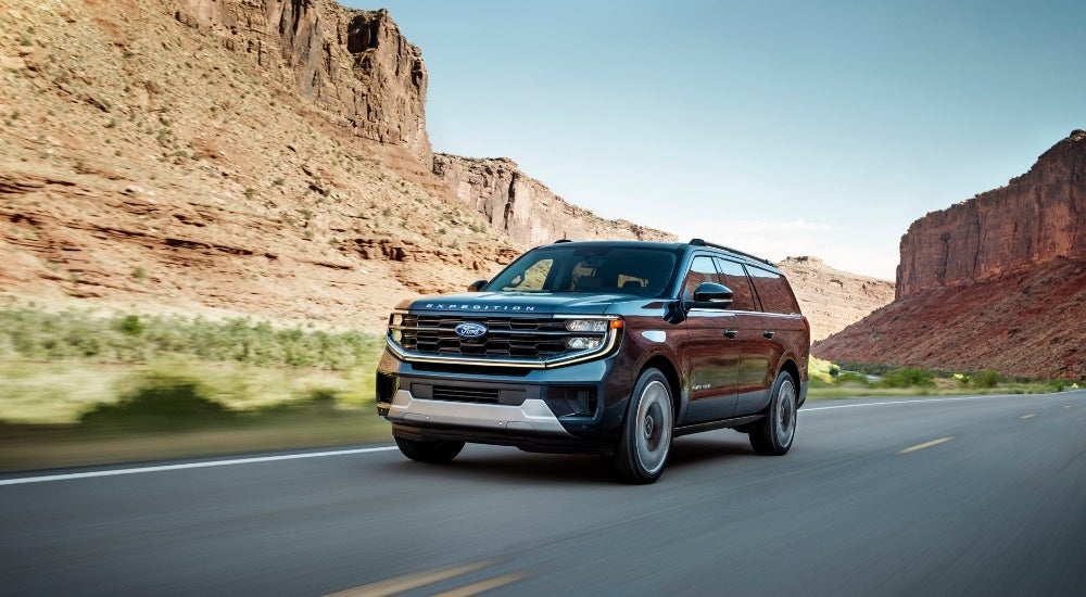 A blue 2025 Ford Expedition Platinum is shown from the front at an angle.
