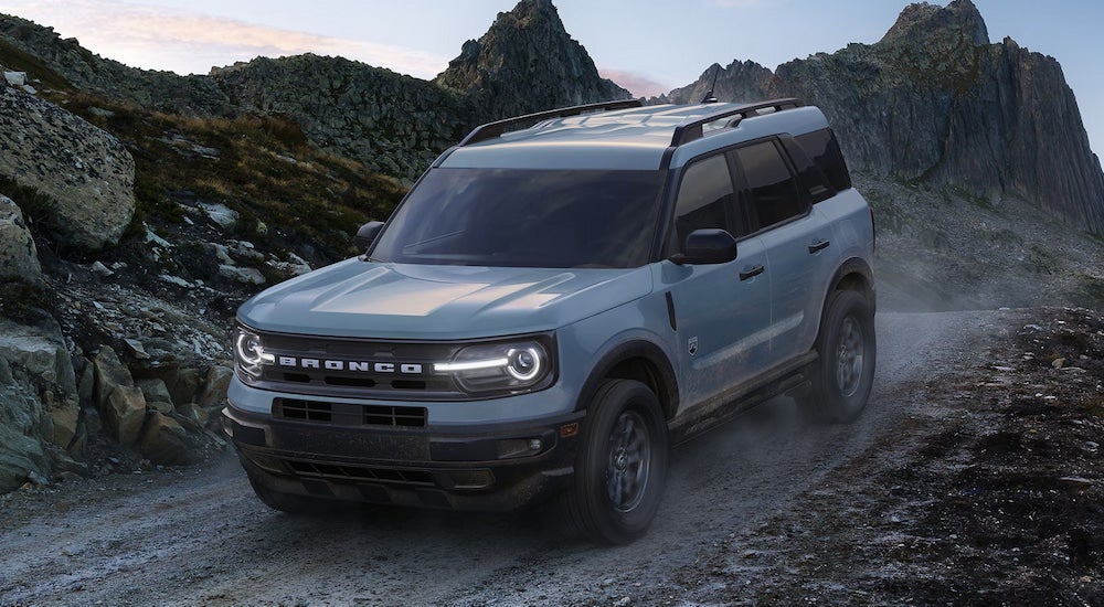 A grey 2023 Ford Bronco Sport driving down a dirt trail.