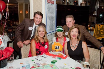 Guests enjoy monopoly with friends and family.