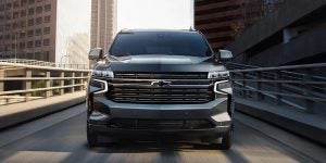 Front view of a dark gray 2021 Chevrolet Tahoe being driven on the road. | Chevrolet dealer in St. Louis, MO