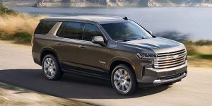 A charcoal 2021 Chevrolet Tahoe being driven on the road. | Chevrolet dealer in St. Louis, MO.