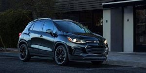 A black 2021 Chevy Trax parked in front of a building. | Chevrolet dealer in St. Louis, MO.