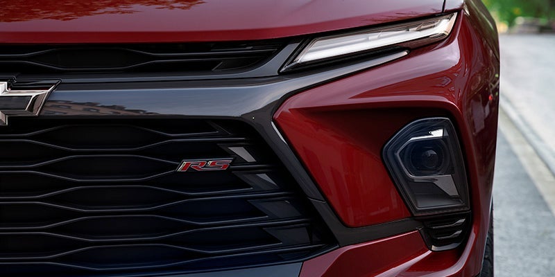 An all new red 2024 Chevy Blazer RS from the front passenger side grill. - Ted Britt Chevrolet Sterling, VA