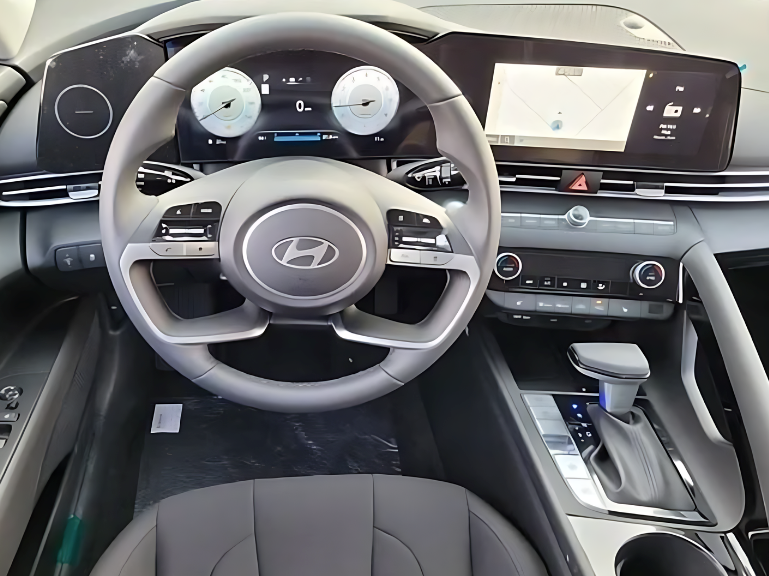 Driver’s view of a Hyundai steering wheel and dual digital displays with navigation and speed indicators, showcasing advanced driving tech