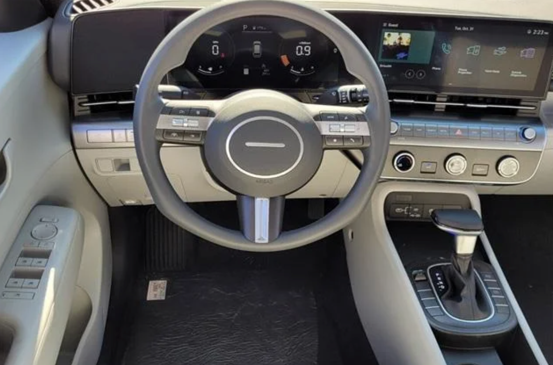 Steering wheel and dashboard of a Hyundai vehicle displaying infotainment and digital features