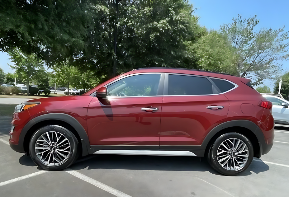 Side profile of a red certified pre-owned Hyundai SUV parked on the lot at Crain Hyundai of Little Rock