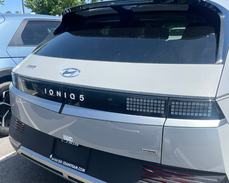 Rear view of a silver Hyundai IONIQ 5 parked at Crain Hyundai dealership