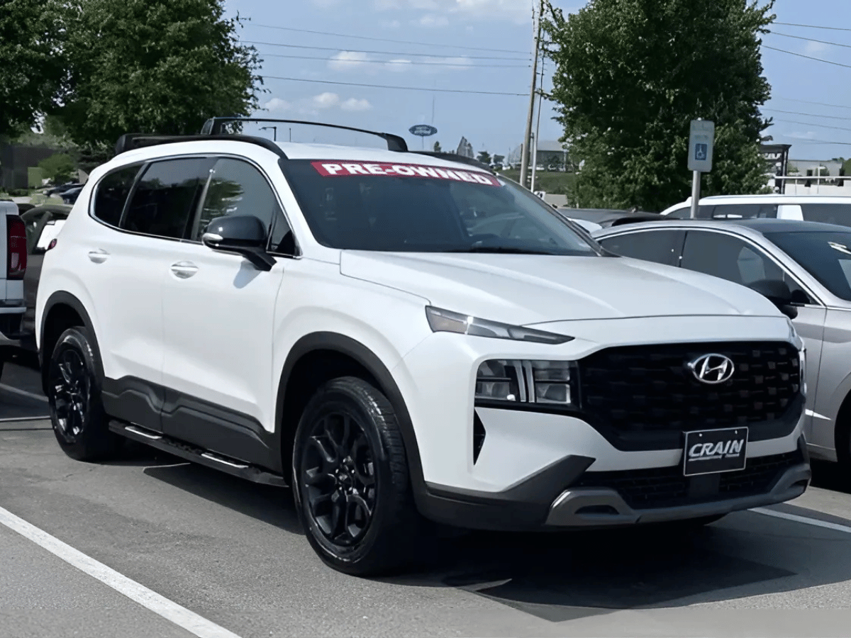 White used Hyundai Santa Fe SUV with pre-owned sign at Crain Hyundai of Little Rock dealership