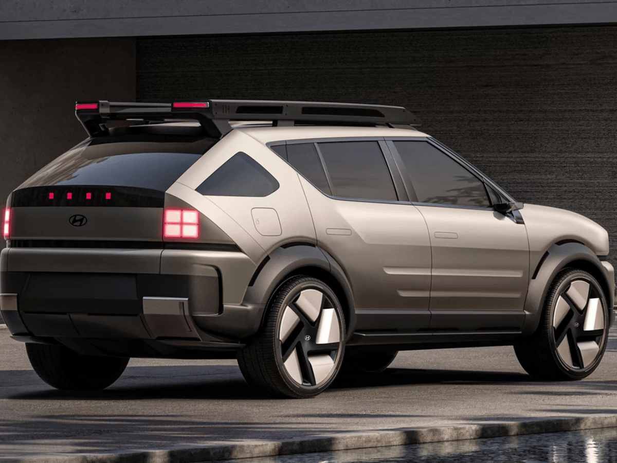 Rear view of the futuristic Hyundai Initium hydrogen-powered SUV parked near a modern building.