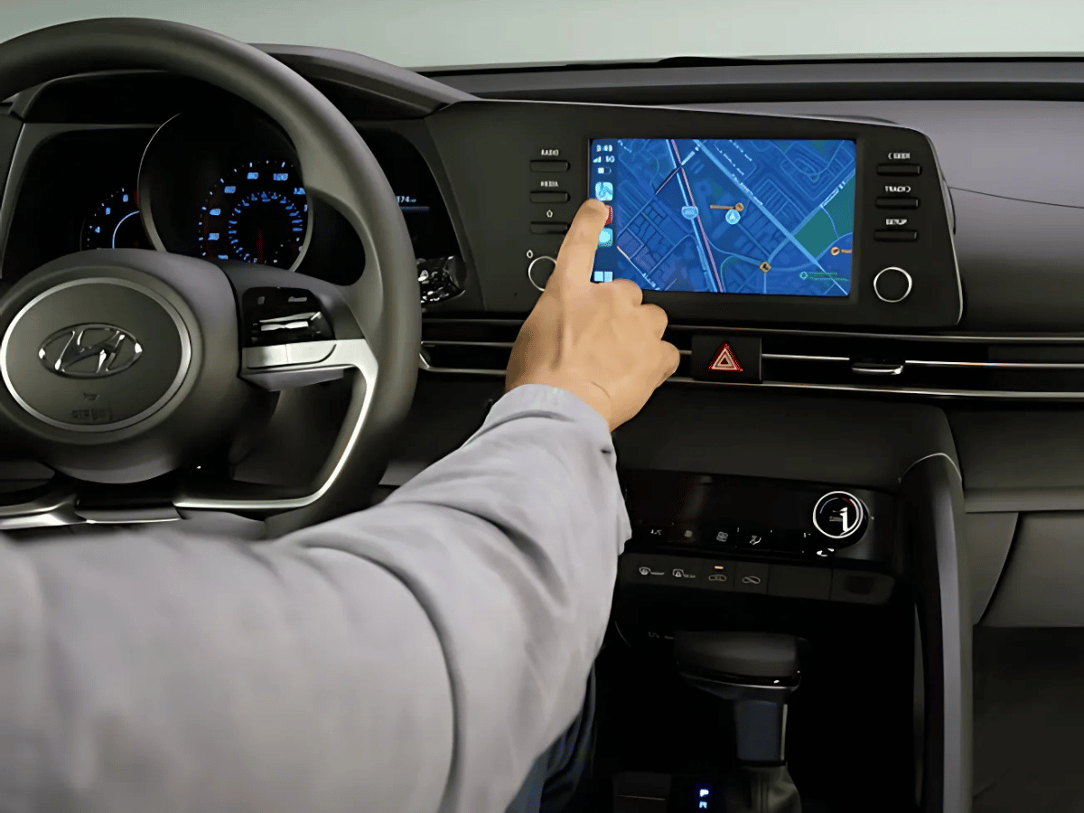 Driver using the touchscreen navigation system with Apple CarPlay in the 2025 Hyundai Kona.