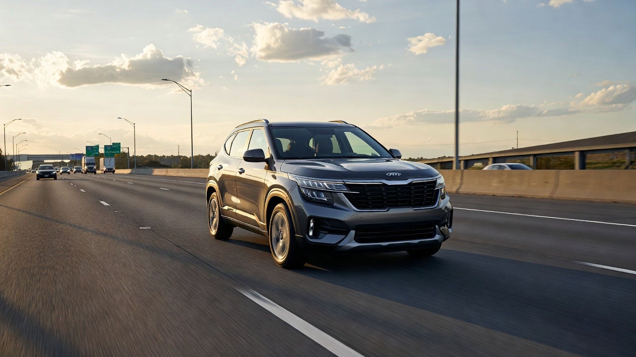 magnific__2026-kia-seltos-cruising-on-highway-at-3pm-sunlit-__79523