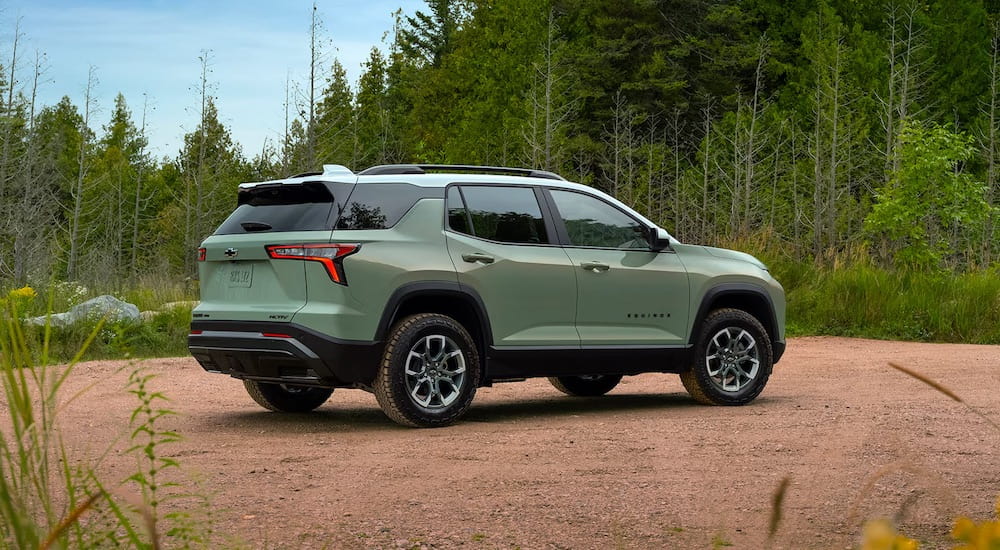 Rear of a green 2025 Chevy Equinox ACTIV parked off-road.