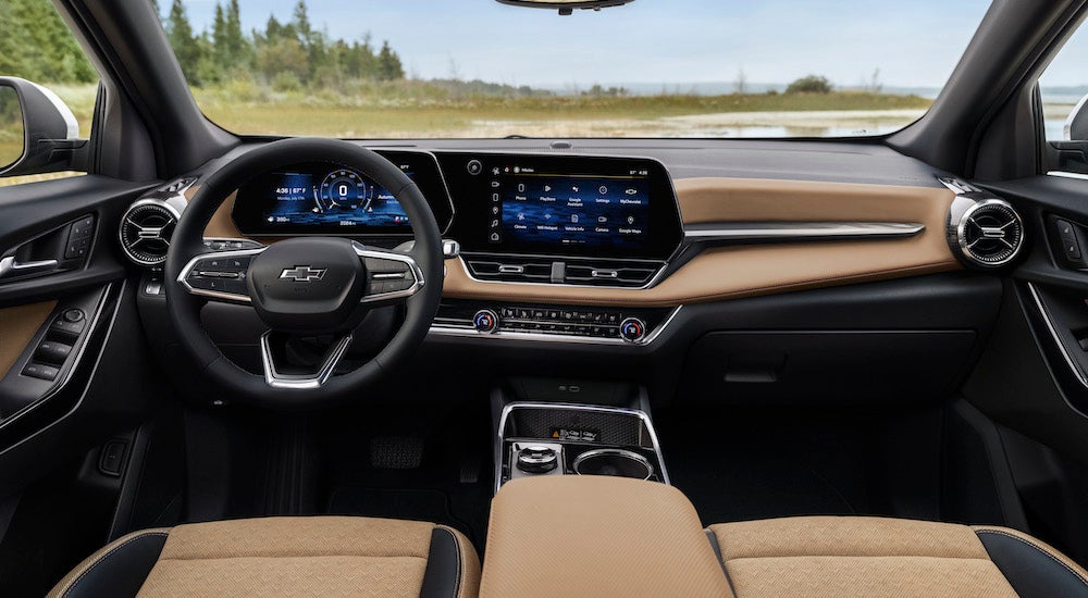 The tan interior of a 2025 Chevy Equinox ACTIV is shown from above the center console.