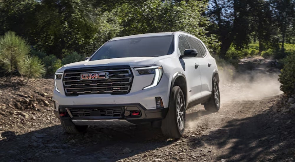 White 2024 GMC Acadia AT4 off-roading