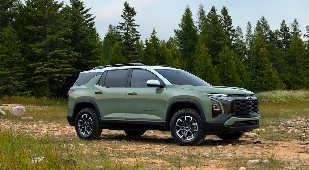 Green 2026 Chevy Equinox for sale in Bloomington parked off-road.