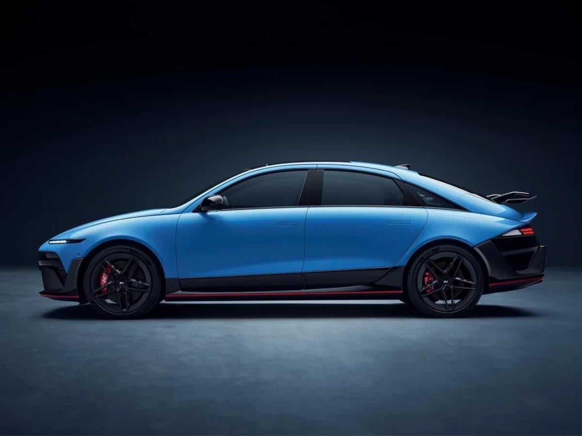 Profile view of the 2026 Hyundai IONIQ 6 N in Performance Blue with black track-ready wheels and a swan-neck rear wing.