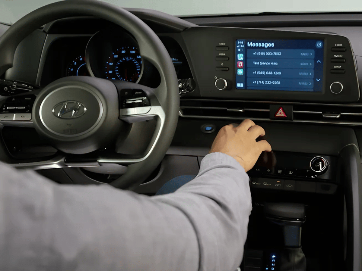 Driver accessing messages through Apple CarPlay on the infotainment screen of a 2025 Hyundai Kona