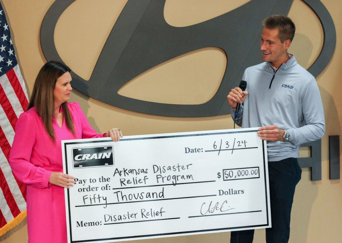 Crain Automotive Team presents a $50,000 donation check to Arkansas Disaster Relief Program