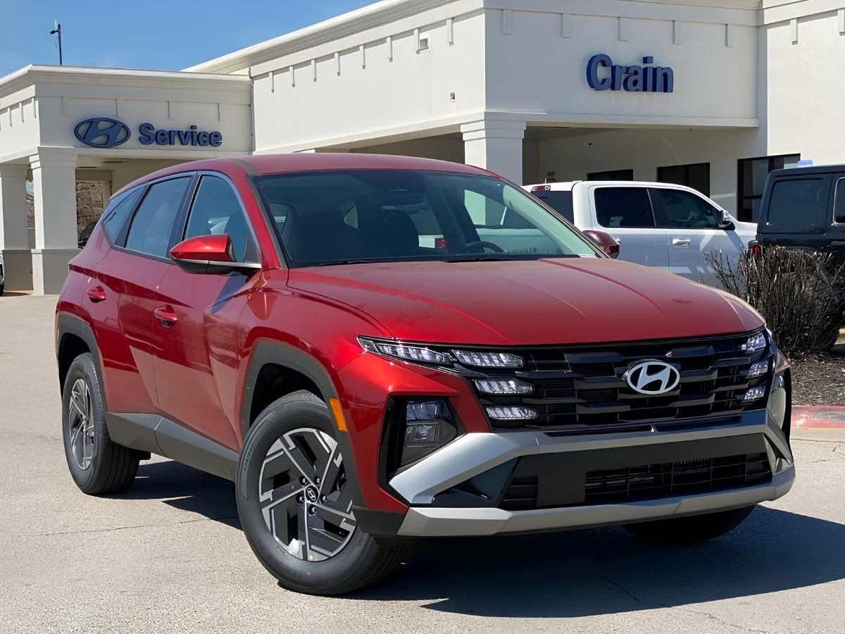 Red Hyundai Tucson parked outside Crain Hyundai of Bentonville dealership