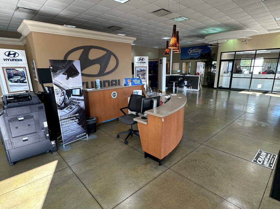 Inside view of the Crain Hyundai of Bentonville finance department with desks and Hyundai branding