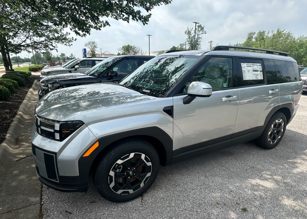 Silver Hyundai SUV parked in dealership lot with Top Safety Pick+ rating window sticker