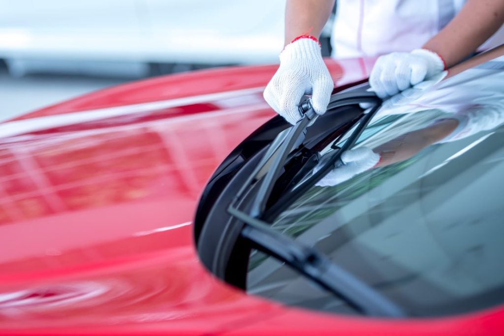 service tech replacing a windshield wiper